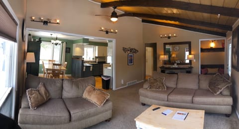 Livingroom w/lofted ceilings, electric fireplace and comfortable couches.