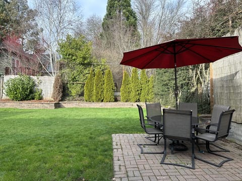 large backyard right next to a park with play structures.  