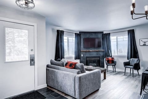The inviting living room, complete with a cozy fireplace.