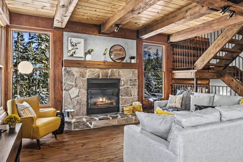 Your dream alpine escape. Featuring soaring timber beams, a majestic stone fireplace, and floor-to-ceiling forest views, our main living area is the height of rustic luxury.