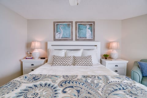 Spacious primary bedroom with seating, ample storage space, and en suite bath.