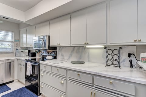 Full kitchen with pots, pans, dishes and barware