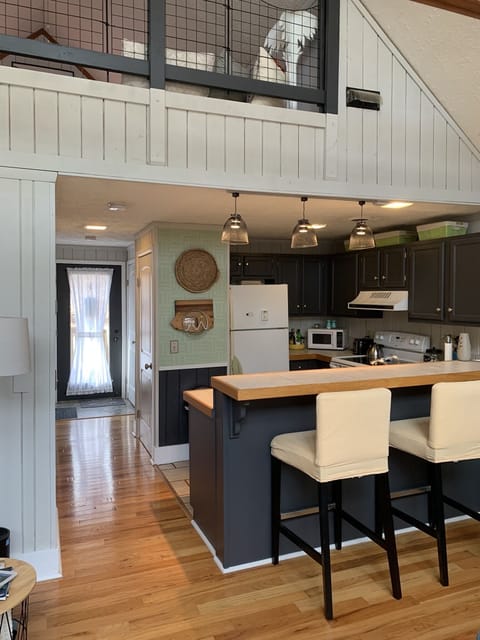 Looking toward front door, kitchen. 