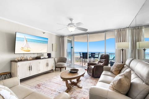 Relax in your oceanfront living room where floor-to-ceiling windows frame endless sea views and your private balcony awaits.