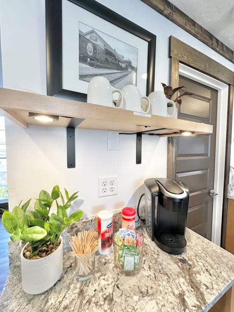 Coffee bar with a K-Cup Keurig, creamer, and an assortment of sugars