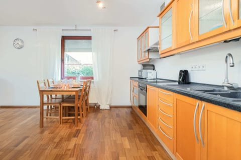 Wooden kitchenette with electric kettle and coffee machine.