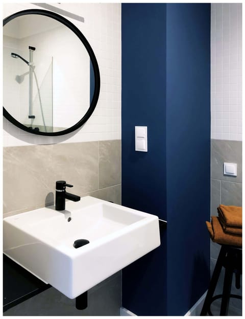 Bright bathroom with washing machine and shower cabin.