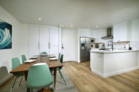 The kitchen opens to the dining area which seats 6.