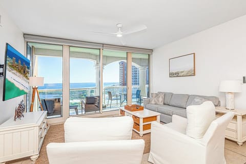 Unwind in your bright coastal living space where floor-to-ceiling windows frame stunning ocean views and modern comfort meets beachside charm.