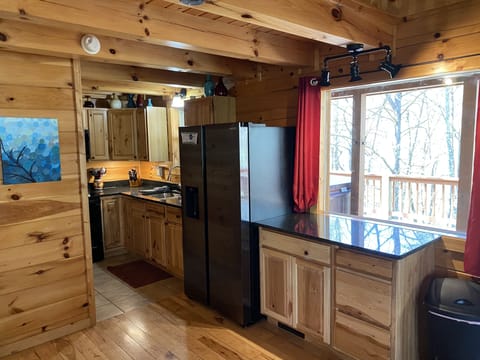 Kitchen equipped with Granite Countertops and Deluxe Fridge 