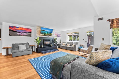 Living Room with Plush Seating for 10 guests, Gas Fire Place, Smart TV, Popcorn Machine, and Nintendo switch, Monopoly, Jenga, dominos, poker set with chips and cards.