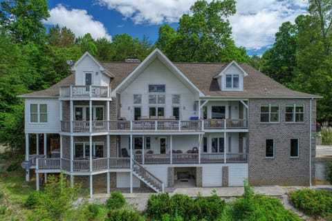 Back of lakefront house 2 covered decks and balcony.  Plenty of seating