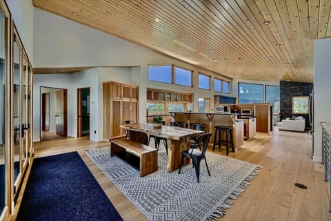 Open-concept kitchen and dining area with natural wood accents and mountain views
