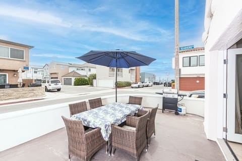 Ocean view from the coveted corner front patio, one house back from beachfront; includes outdoor dining, propane bbq grill, market umbrella.
                
