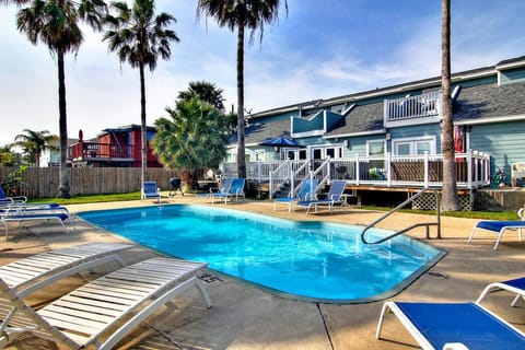 Dive into your tropical oasis! This sparkling pool surrounded by swaying palms creates the perfect backdrop for your relaxing getaway.