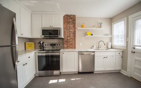 Kitchen 1 with beautiful exposed brick-fully renovated and upgraded amenities