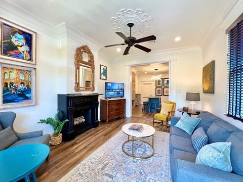Comfortable living room with vibrant art, sofa bed and smart TV