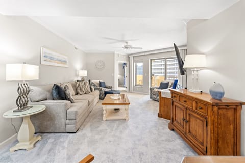 Comfortable Living Room with large TV and balcony access