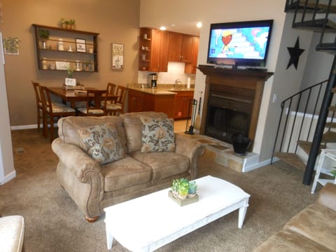 Living / Dining. Spiral stairs case to loft.