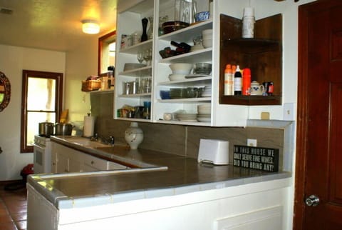 Full kitchen stocked with basic utensils