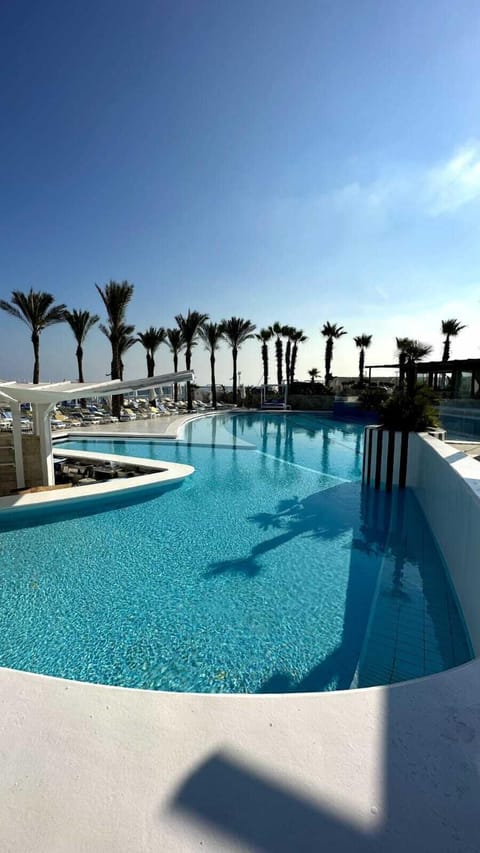 Seasonal outdoor pool, open 9:00 AM to 6:00 PM, pool umbrellas