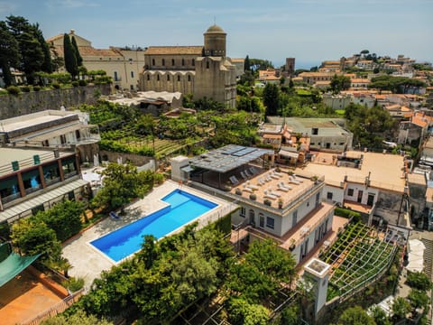 Seasonal outdoor pool, open 11:00 AM to 7:00 PM, pool umbrellas