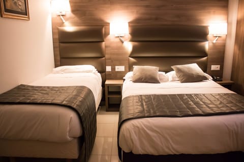 Triple Room | Down comforters, minibar, in-room safe, laptop workspace