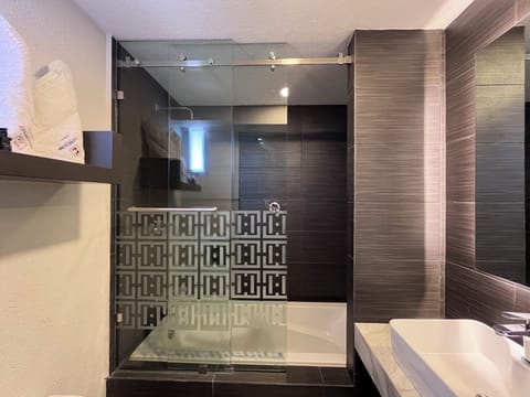 Deluxe Room, 1 King Bed | Bathroom | Shower, rainfall showerhead, designer toiletries, towels