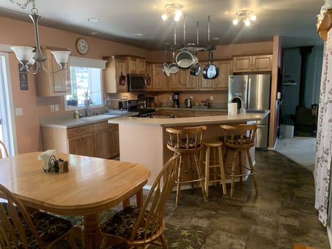 Large kitchen with island bar and dining room. Seating for 10+