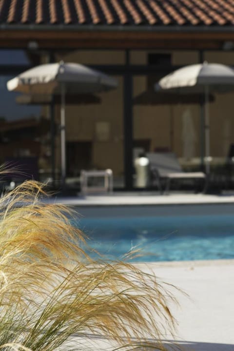 Seasonal outdoor pool, open 8:00 AM to 8:00 PM, pool umbrellas