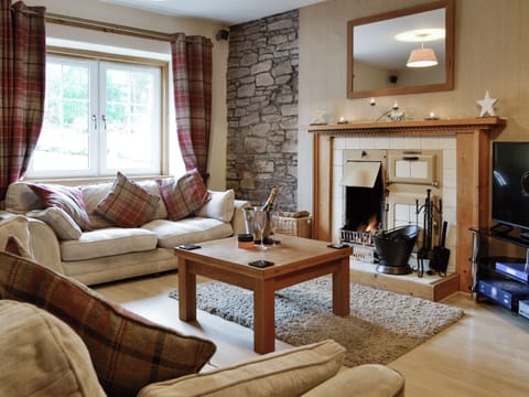 Welcoming living area with open fire | Baldowrie Farm Cottage, Kettins, near Blairgowrie