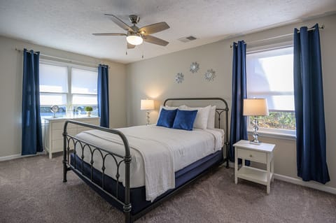 Oversized master bedroom with king size bed well suited for two.