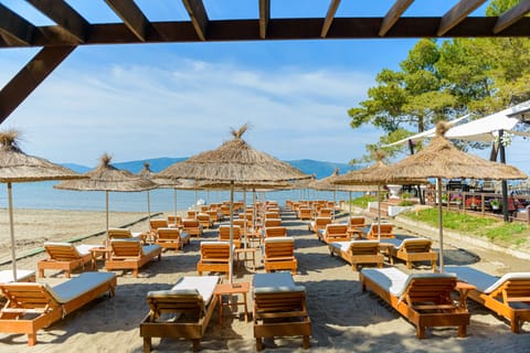 Private beach, black sand, sun loungers, beach umbrellas