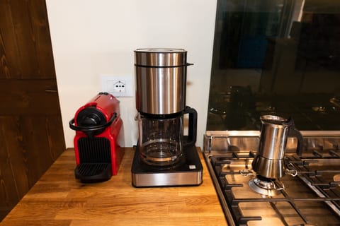 Caffè three ways: Nespresso, traditional American coffee maker, and two Mokas.