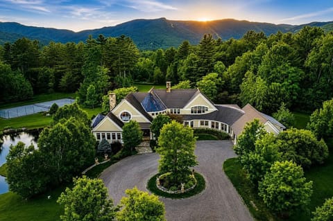 The estate, upper spring-fed pond + tennis court w/ Mt. Mansfield in the back