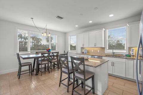 Kitchen and island breakfast bar right by the living room