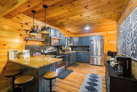 Updated, open-concept kitchen with stainless appliances, tile backsplash, and casual eat-in and bar seating.