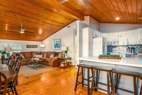 Spacious living room with ample seating, a Smart TV, and ceiling fan for comfort. The sofa converts into a bed, and two ottomans unfold into twin beds—perfect for extra guests. An ideal spot for games, relaxing, and entertaining.
