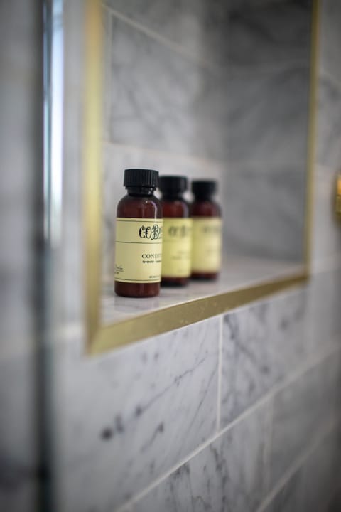 Shower, rainfall showerhead, designer toiletries, hair dryer