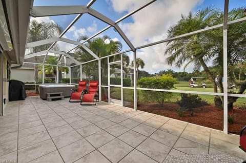 CC21040 - The screened in patio offers a covered dining area, seating and lounging area and a hot tub.
