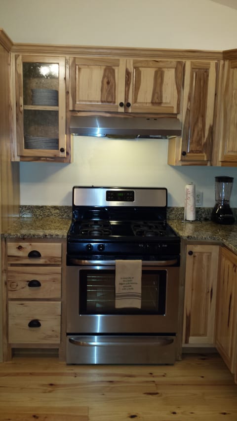 Gas stove with granite counters, dishwasher and refrigerator.