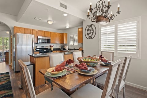 The kitchen is well-equipped with modern stainless steel appliances and updated amenities