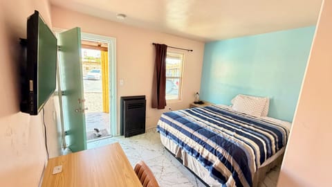 Deluxe Room, 1 Queen Bed, Refrigerator & Microwave, Ground Floor | Desk, blackout drapes, iron/ironing board (on request), WiFi (free)