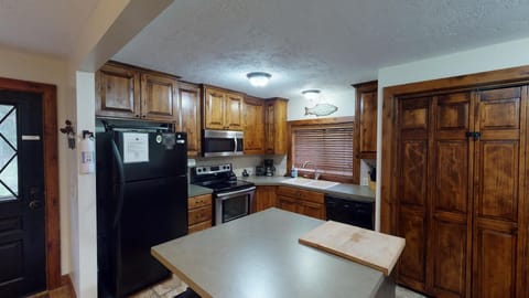 This kitchen is equipped with basic appliances, dishes, and cookware you might need,