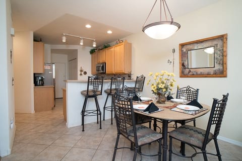 Dining room has ample seating at the table and bar counter.