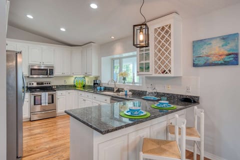 The bright and spacious kitchen features a handy breakfast bar.