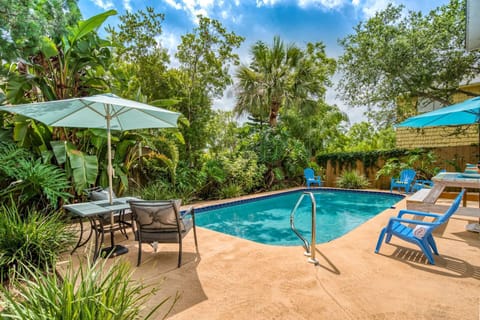 The private, heated pool and deck is surrounded by lush tropical landscape.
