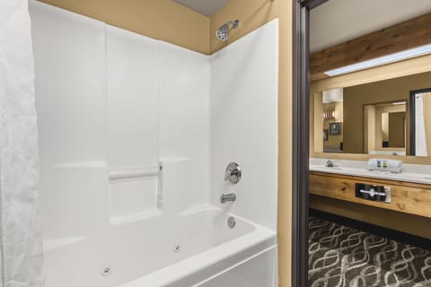 Suite, 1 King Bed | Bathroom | Combined shower/tub, hair dryer, towels