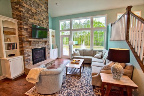 Your Family Room on Main Floor w Sloped Ceilings and View of Pond and Woods