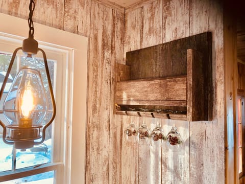 Wine rack over drop leaf table in the kitchen.